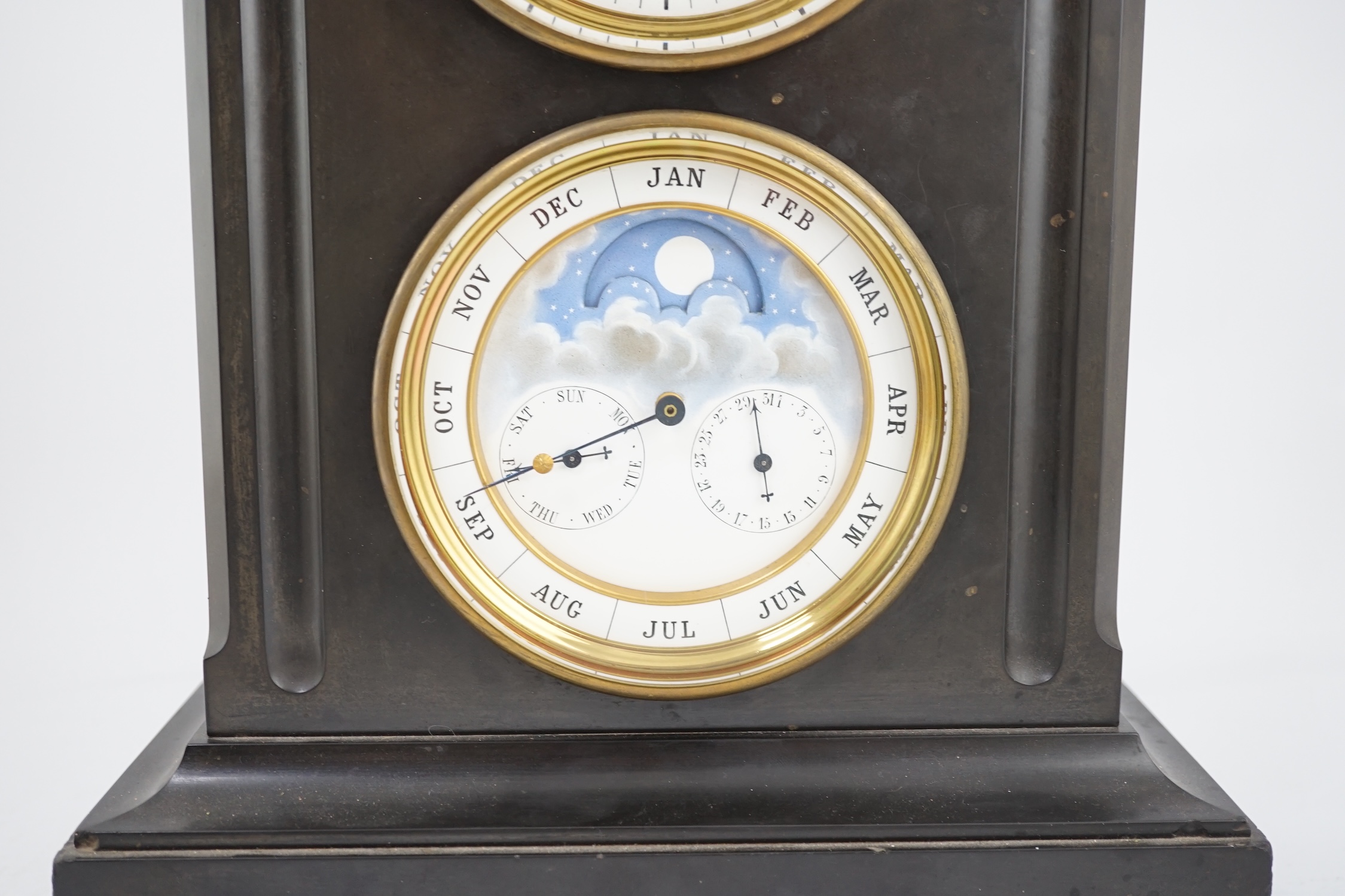 A late 19th century French black slate calendar mantel clock